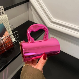 Metallic hot pink cylindrical acrylic handbag with elegant top handle and gold chain