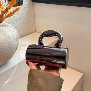 Minimalist black cylinder acrylic handbag with glossy finish and golden metal chain