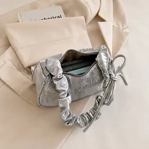 Silver-grey pleated crescent bag interior showing capacity for daily essentials
