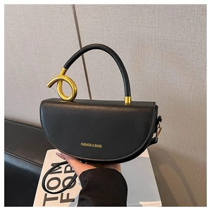 Detail of black leather saddle bag featuring gold ring accent and Fashion & Bags gold lettering