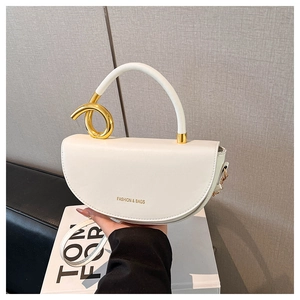 Detail of white saddle bag showing golden twisted metal ring and fashion text print