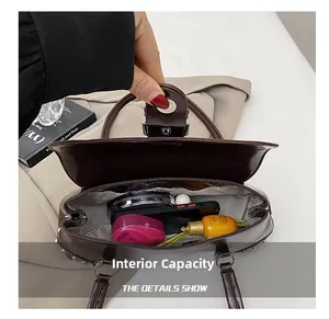 Internal capacity of the dark brown leather handbag showing compartments and daily items