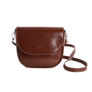 Minimalist dark brown half-moon crossbody bag with glossy oil leather finish and flap