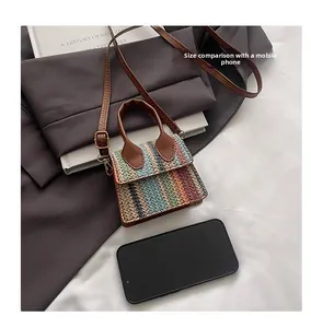Size comparison of a colorful woven crossbody bag next to a smartphone device