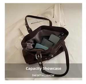 Top view showing the large capacity of a brown suede tote bag with daily essentials