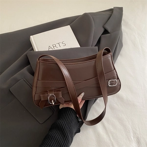 Deep brown matte leather shoulder bag with buckle straps and silver metal hardware accents