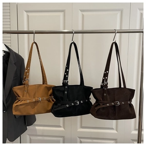 Hanging display of underarm bags in camel, black, and coffee with silver belt buckles