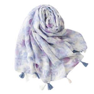 Blue and purple floral cotton linen scarf with tassels in a stylish spiral arrangement