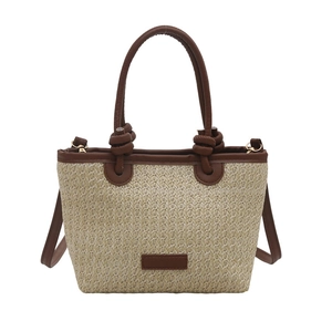 Pastoral straw bucket bag with brown leather trim and knot handles for summer style