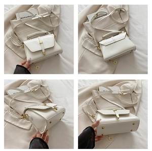 Multi-angle views of white crossbody bag with gold ring closure and protective base studs