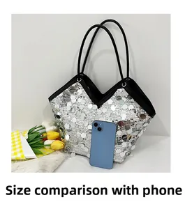 Silver sequin tote bag showing large capacity compared to a smartphone reference