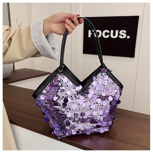 Close-up of purple sequin evening bag featuring a V-shaped opening and black handles