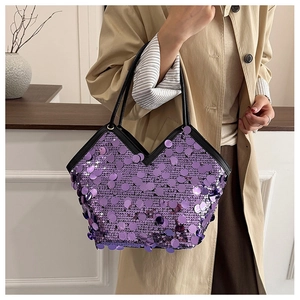 Detailed close-up of a purple sequin tote bag with sleek black straps and a V-shaped top