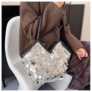 Detail of silver sequin shoulder bag with black trim and elegant V-shaped opening
