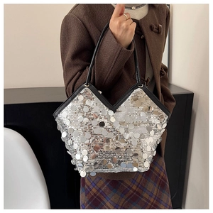 Detail of silver sequin tote bag with V-shaped opening and black leather strap