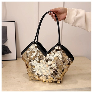 Detail of champagne gold sequin tote bag with black faux leather trim and v-shape opening