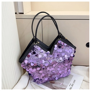Detailed view of purple sequins, black leather trim, and gold hardware on tote bag