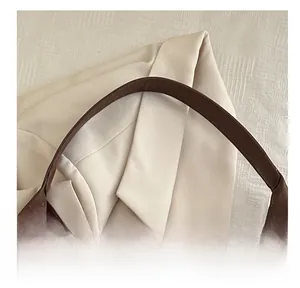 Gros plan de la large poignée en cuir souple avec coutures nettes sur un sac cabas