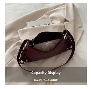 Capacity display of dark red half-moon shoulder bag with phone and cosmetics inside