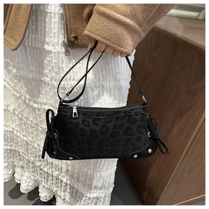 Detail of leopard print shoulder bag with silver studs and decorative knots on the side
