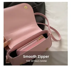 Internal view of pink leather handbag with smooth zipper pouch and secure snap closure