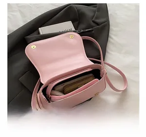 Macro shot of pink crossbody bag interior capacity with double magnetic buckles