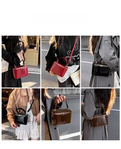 Outdoor street style view of glossy patent leather mini box bag with top handle and strap