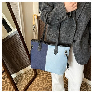 Close-up of contrast stitching and denim leather mix on this large tote shoulder bag