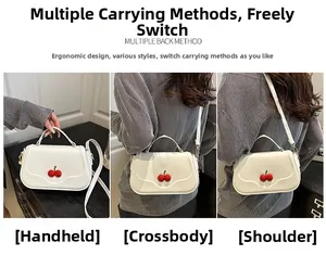 Three-way carry demonstration of white crossbody bag with 3D cherry decor