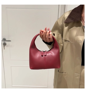 Detailed view of deep red hobo bag with smooth leather texture and dual zipper detail