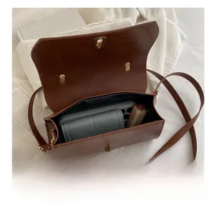 Internal view of brown retro crossbody bag showing capacity for phone, wallet and lipstick