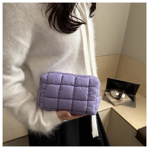 Close-up of lavender quilted nylon makeup bag showing puffy texture and zip closure