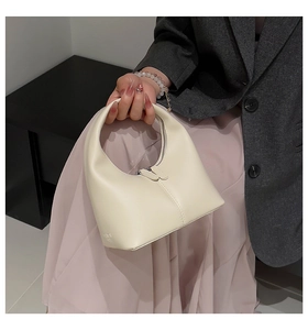 Close-up of beige hobo bag with zip closure and fashion embossed detail on textured leather
