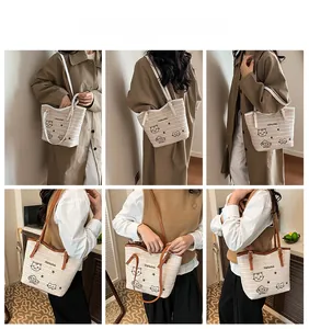 Détail du sac cabas tissé avec motif de chat brodé et bandoulières contrastées