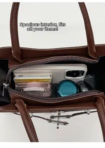 Detail view of large capacity dark brown tote bag interior with multiple storage items