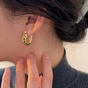 Elegant gold-tone chunky hoop earrings with bold leopard print pattern for women