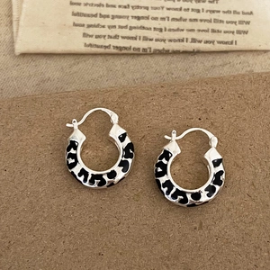 Vintage silver hoops with black leopard print enamel on aesthetic retro fabric