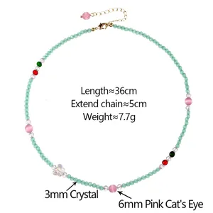 Light green crystal necklace with pink cat's eye beads and butterfly charm design