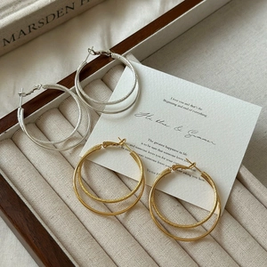 Elegant gold and silver double-hoop earrings with smooth and frosted texture mix