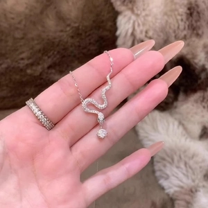 Exquisite silver snake pendant necklace featuring white cubic zirconia and a round main stone