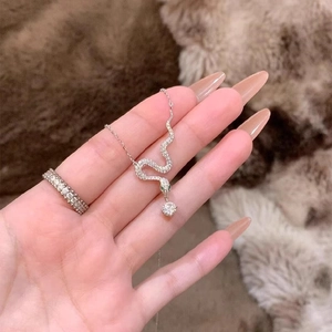 Elegant silver snake necklace with green zircon eyes and crystal paved ring set
