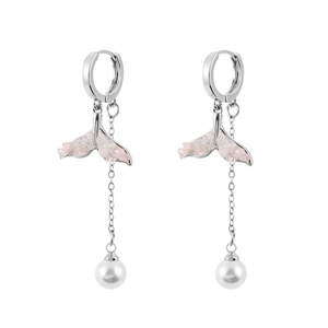 Detail view of silver whale tail earrings with pink crystal and long pearl tassels