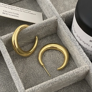 Minimalist thick gold-plated C-shape hoop earrings with a high-polished mirror finish