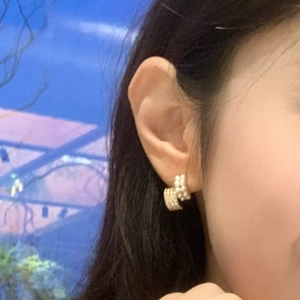 Elegant gold double-row huggie earrings featuring lustrous white pearls and sparkling zircons