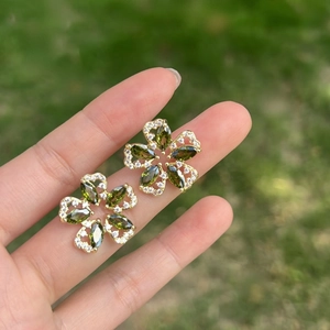 Golden flower stud earrings with olive green marquise zircons and white crystals