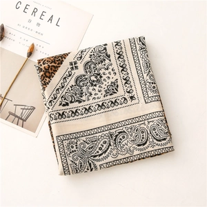 Macro view of paisley and leopard print patterns on soft cotton-linen feel scarf