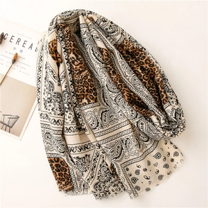 Detail of bohemian scarf with leopard and paisley prints and soft frayed edges