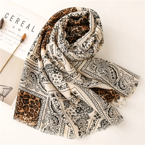 Detail of soft pashmina shawl with leopard and paisley print with fringe edges