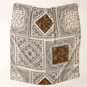 Close-up of paisley and leopard print pattern on lightweight linen-feel scarf fabric