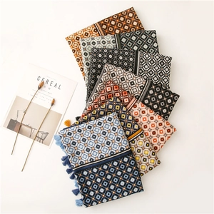Close-up of geometric diamond print scarves with fringe tassels in various colors